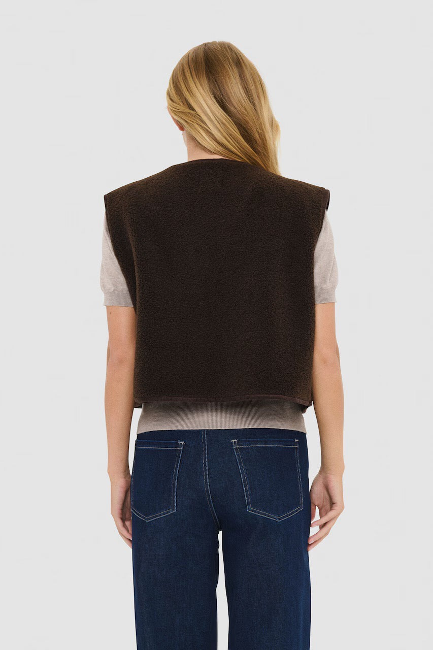 Back view of the Saint Tropez IcariaSZ mocha fleece vest on a model, worn over a light top with blue jeans