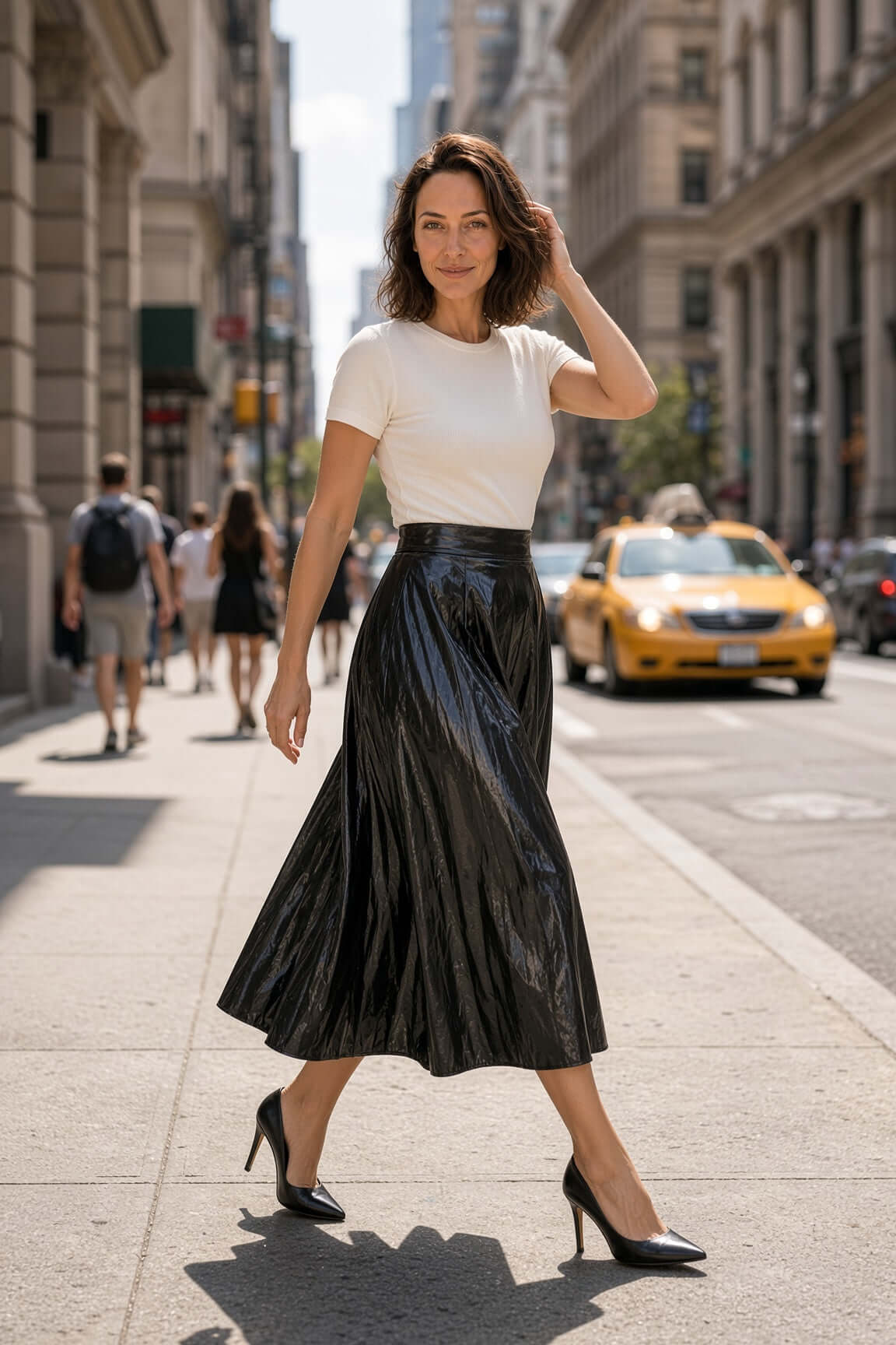Marciano by Guess Faux Leather Pleated Midi Skirt – Black, a chic women's fashion statement skirt in a city setting.
