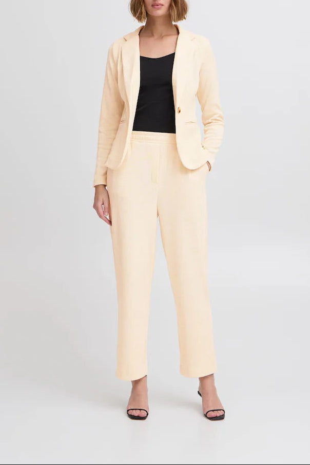 Model wearing the ICHI KATE ivory corduroy blazer with a black top and matching ivory trousers, full-length front view.