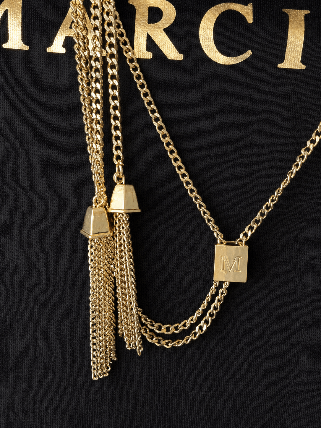 Marciano by Guess Logo T-Shirt with Gold Chain Necklace – Black, showcasing layered gold chains with M-logo pendant.