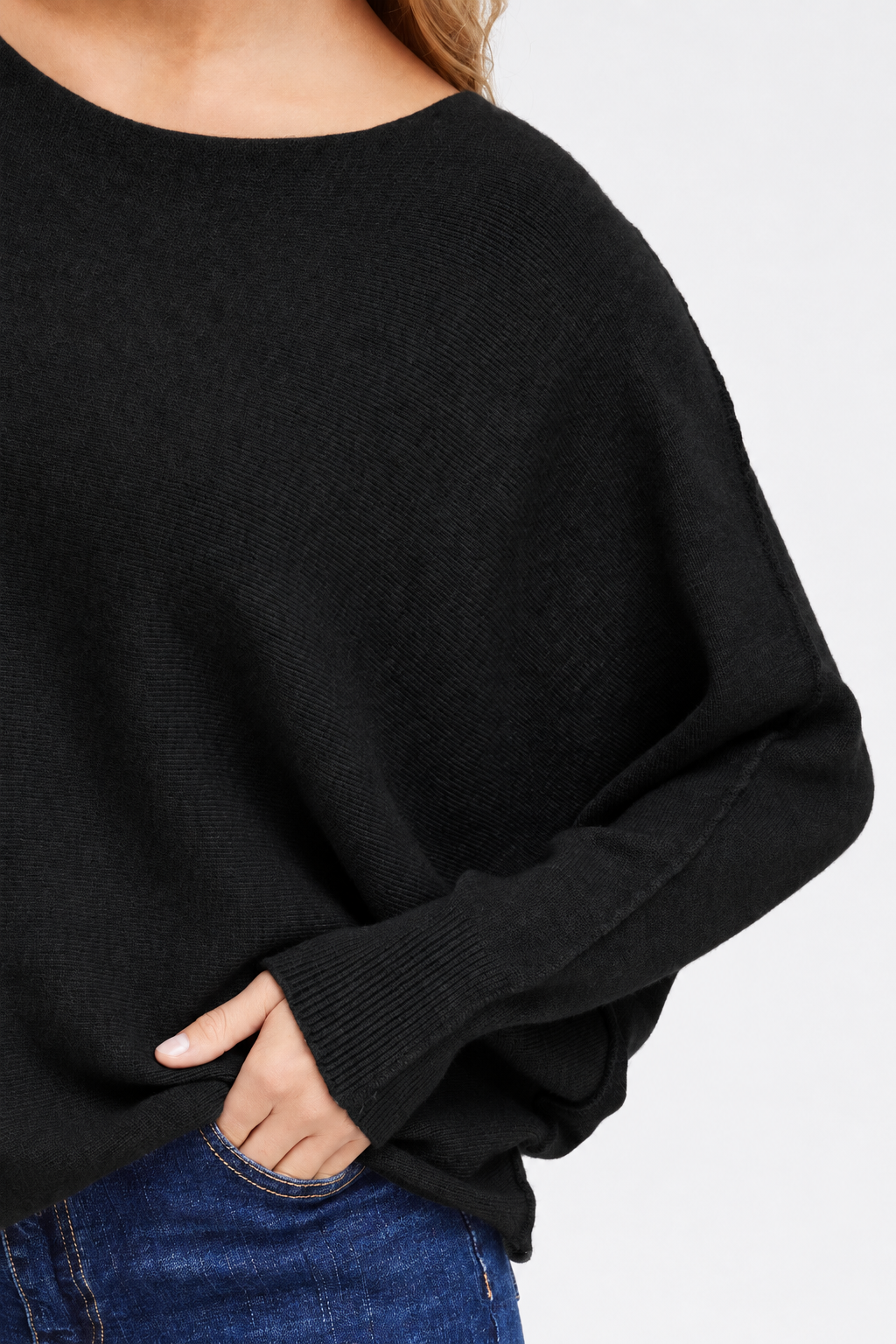 Detail of the Sorbet Basil black knit jumper showing the long sleeve, ribbed cuff and knitted texture